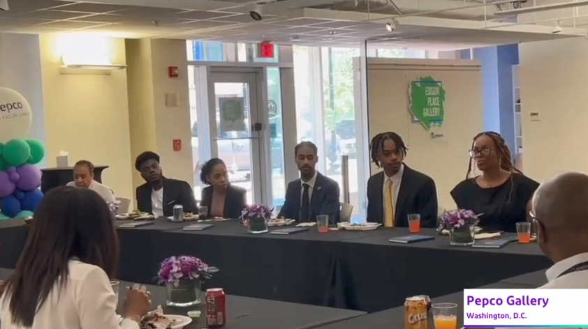 Students seated at a long table.