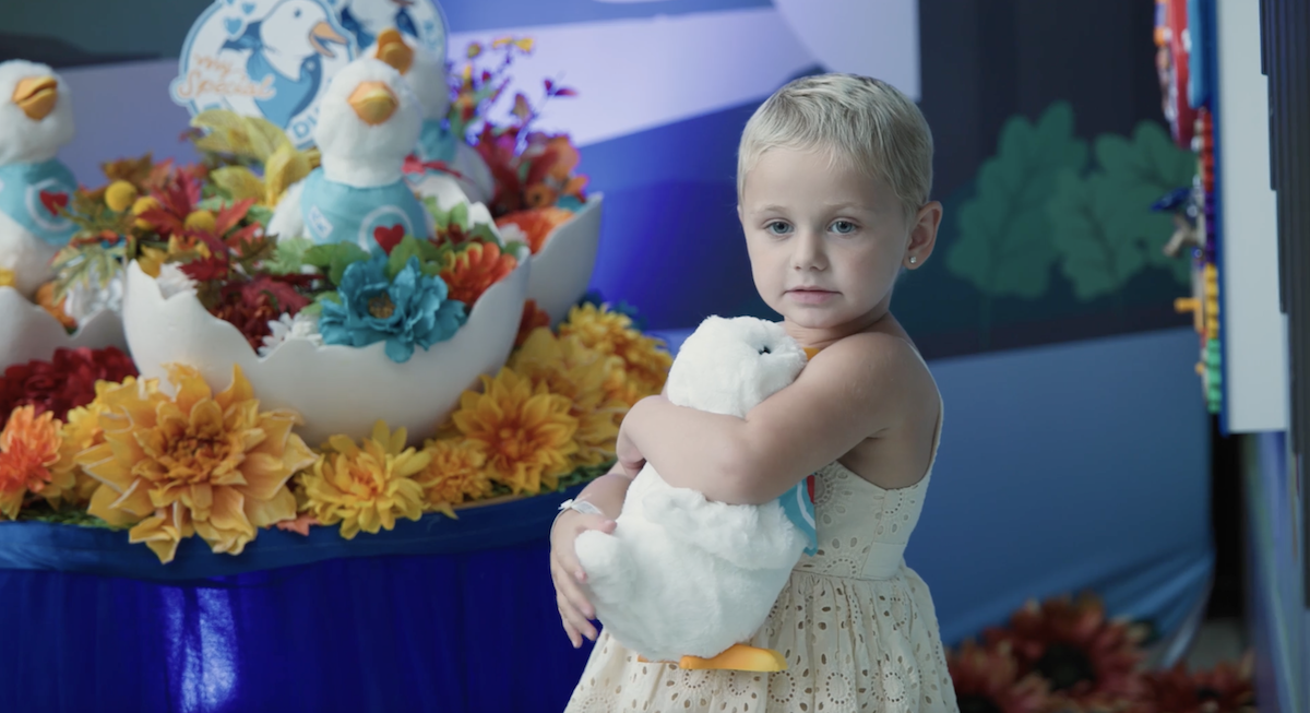 Young girl holding her Aflac My Special Duck