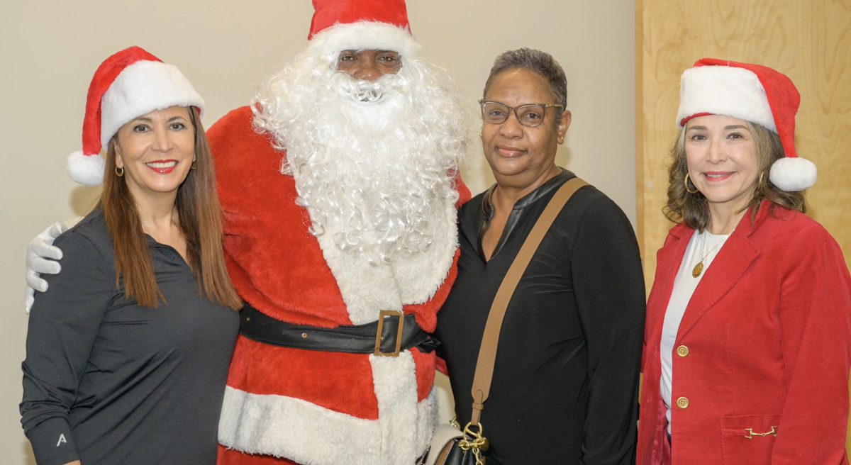 Customer meeting Entergy officials and person dressed up as Santa