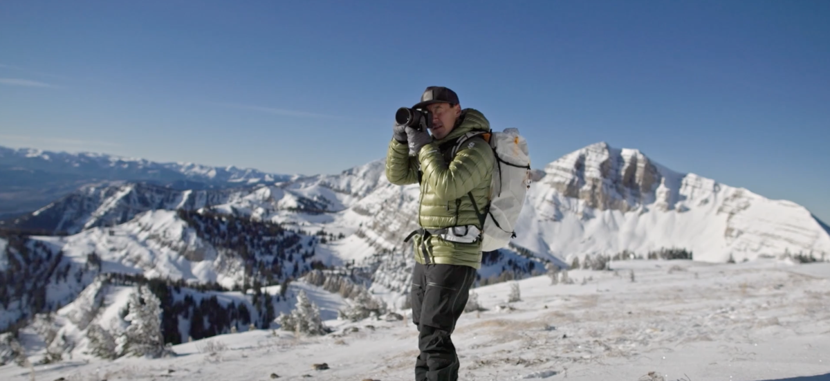 Jimmy Chin taking a photo on a mountaintop 