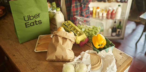 A table with food on it and a bag that reads "Uber Eats"