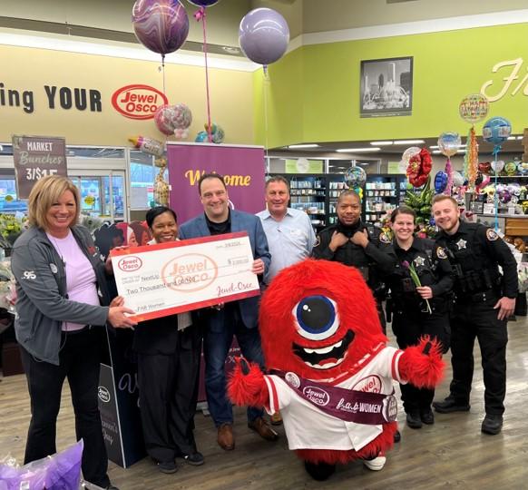 Group of people holding a check in a Jewel-Osco store