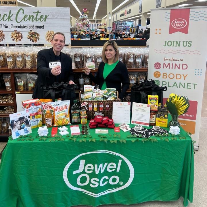 People posing at booth at Jewel-Osco Mind, Body, Planet event