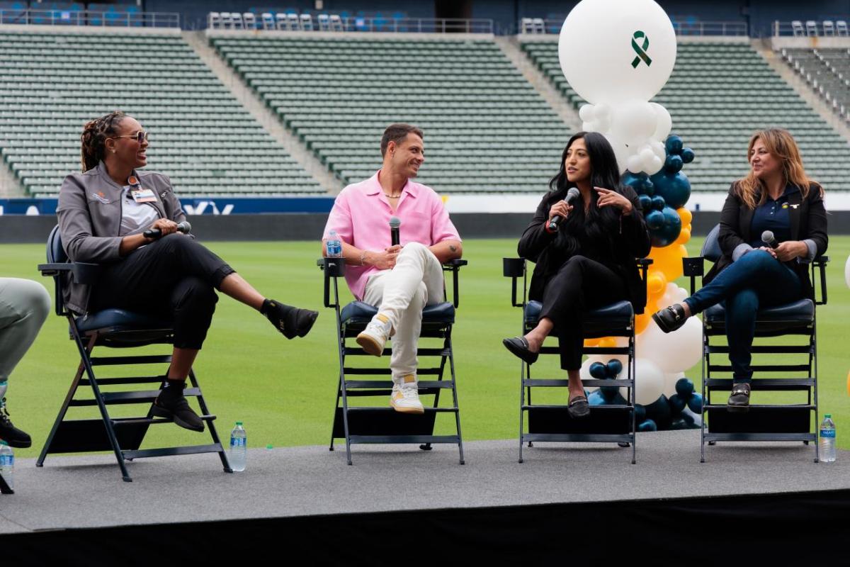 Seated people talking with each other on a stage