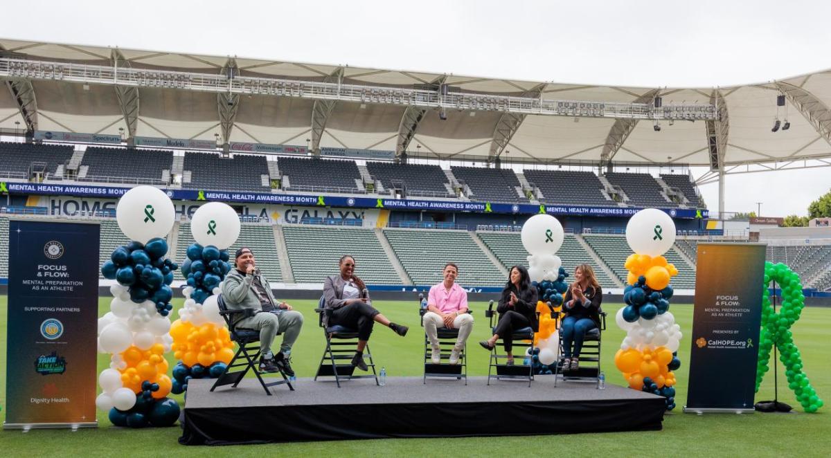 People sitting in folding chairs in a stadium