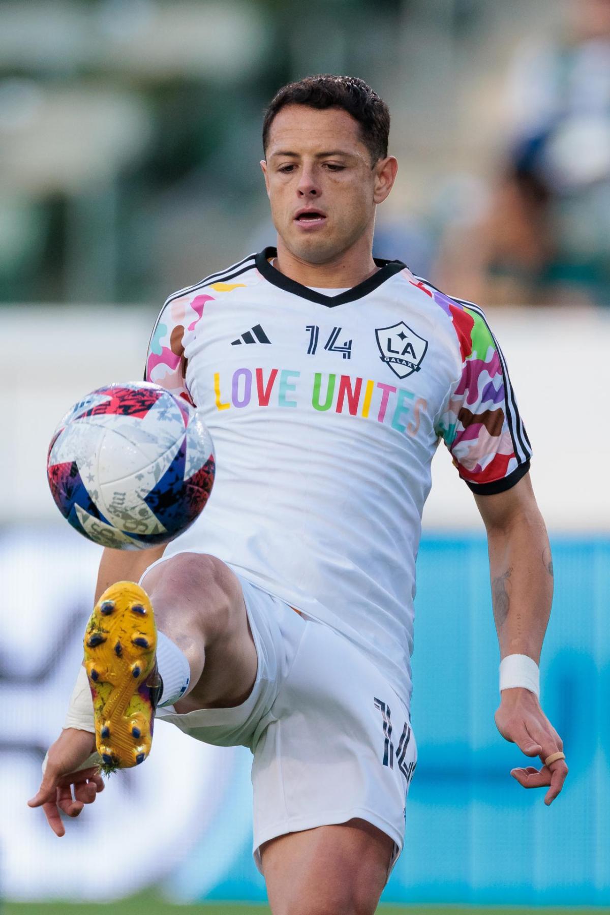 Chicharito warming up while wearing Pride Night jerseys.