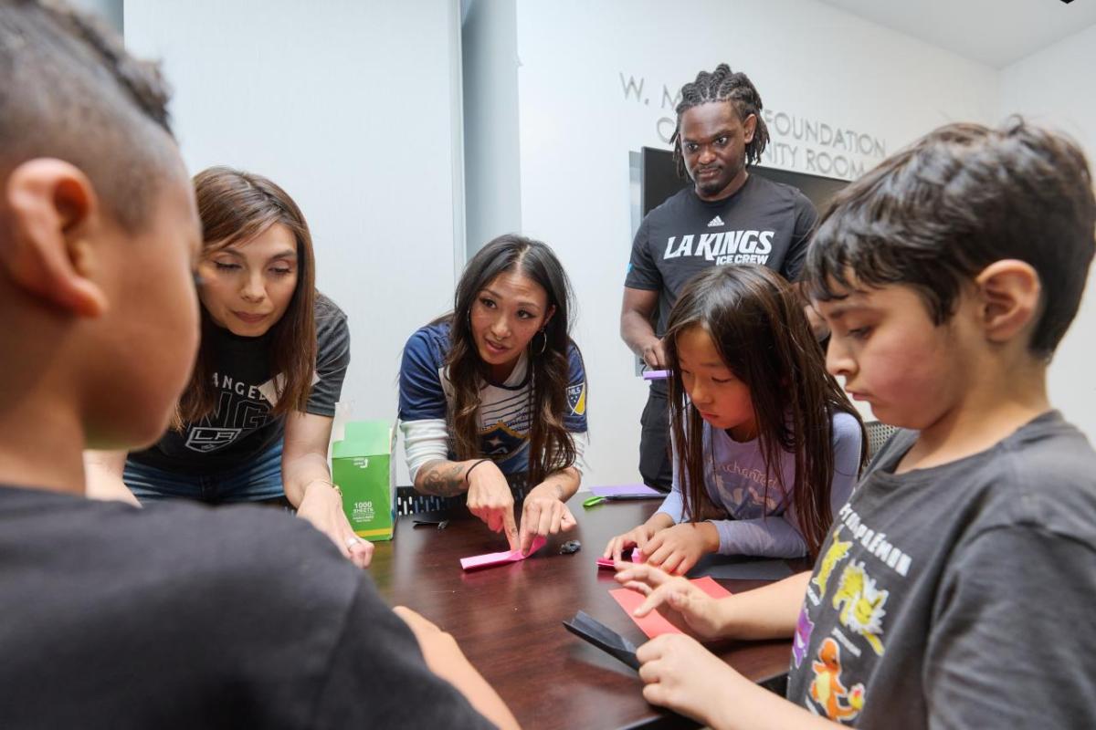Children from Little Tokyo Service Center learn about hockey with the LA Kings Ice Crew.