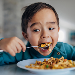 Albertsons Companies Foundation celebrates 10 years and $297 million raised for its Nourishing Neighbors charitable program dedicated to fighting hunger. (Photo: Business Wire) Child eating cereal