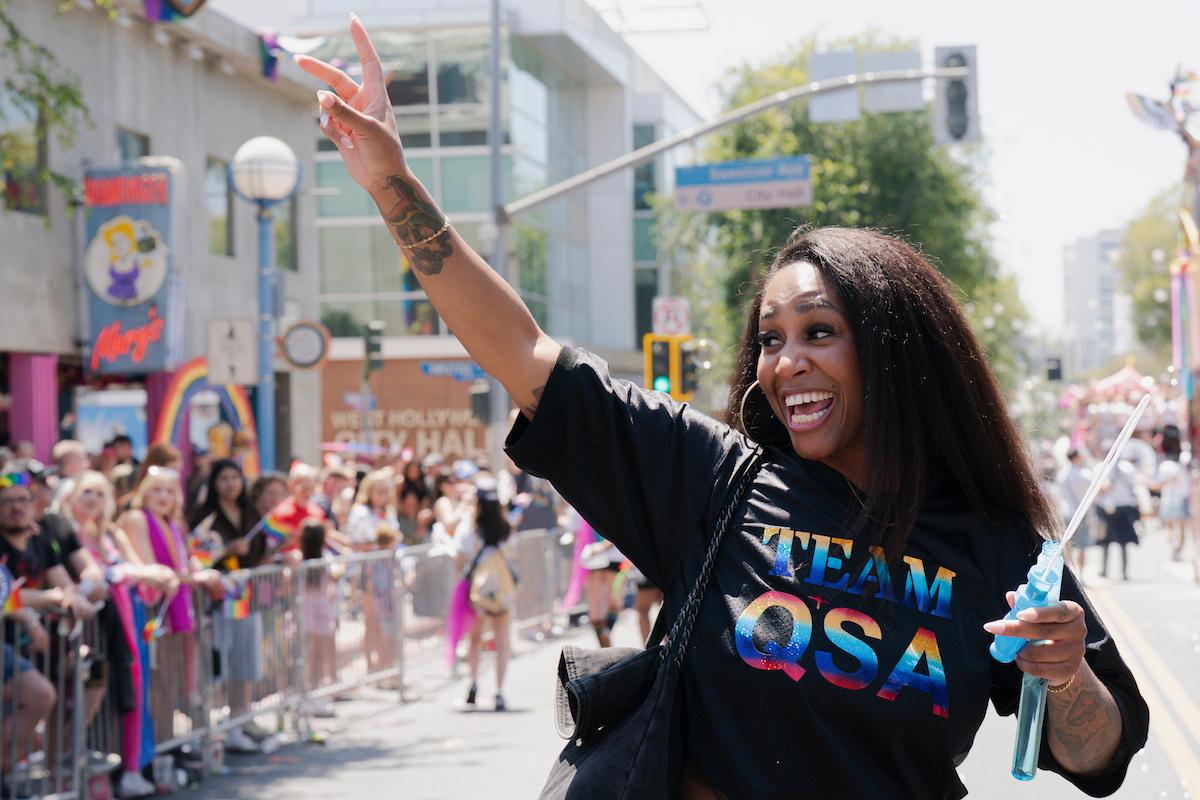 Team QSA marches with bubbles and peace sign in air