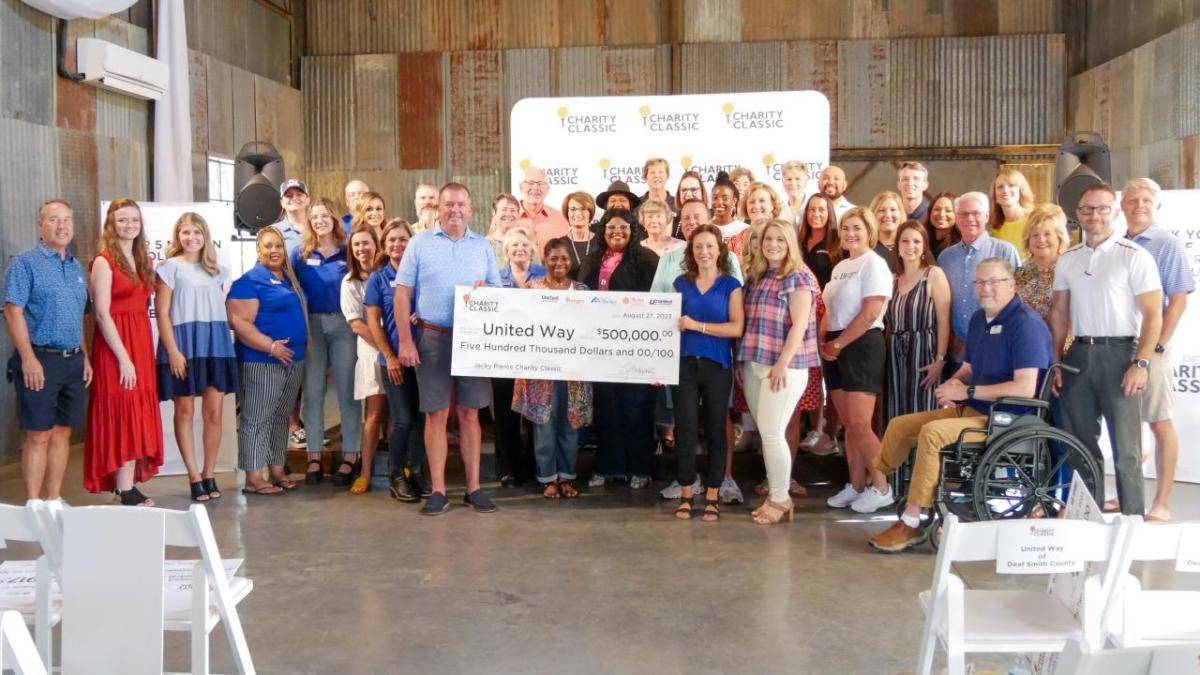 Group of people holding a check