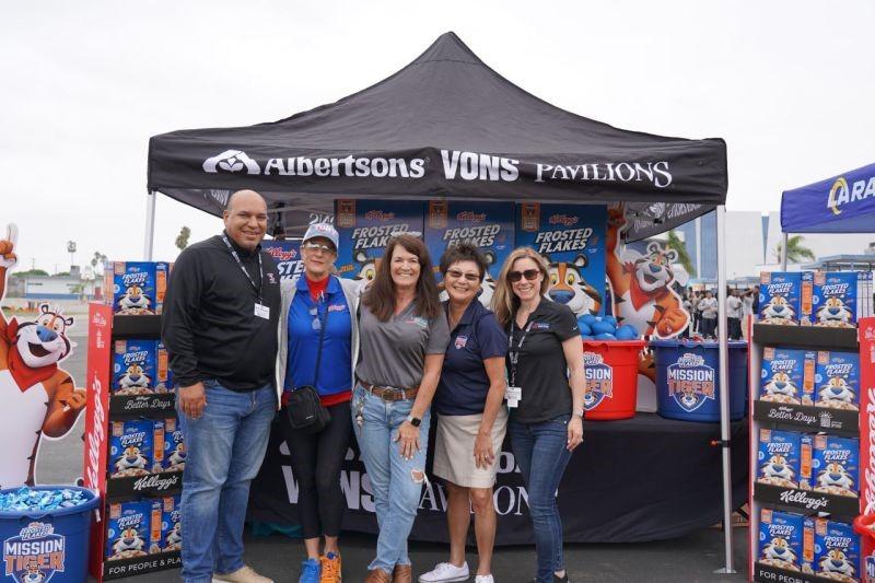 Group of people smiling in front of Albertsons' tent