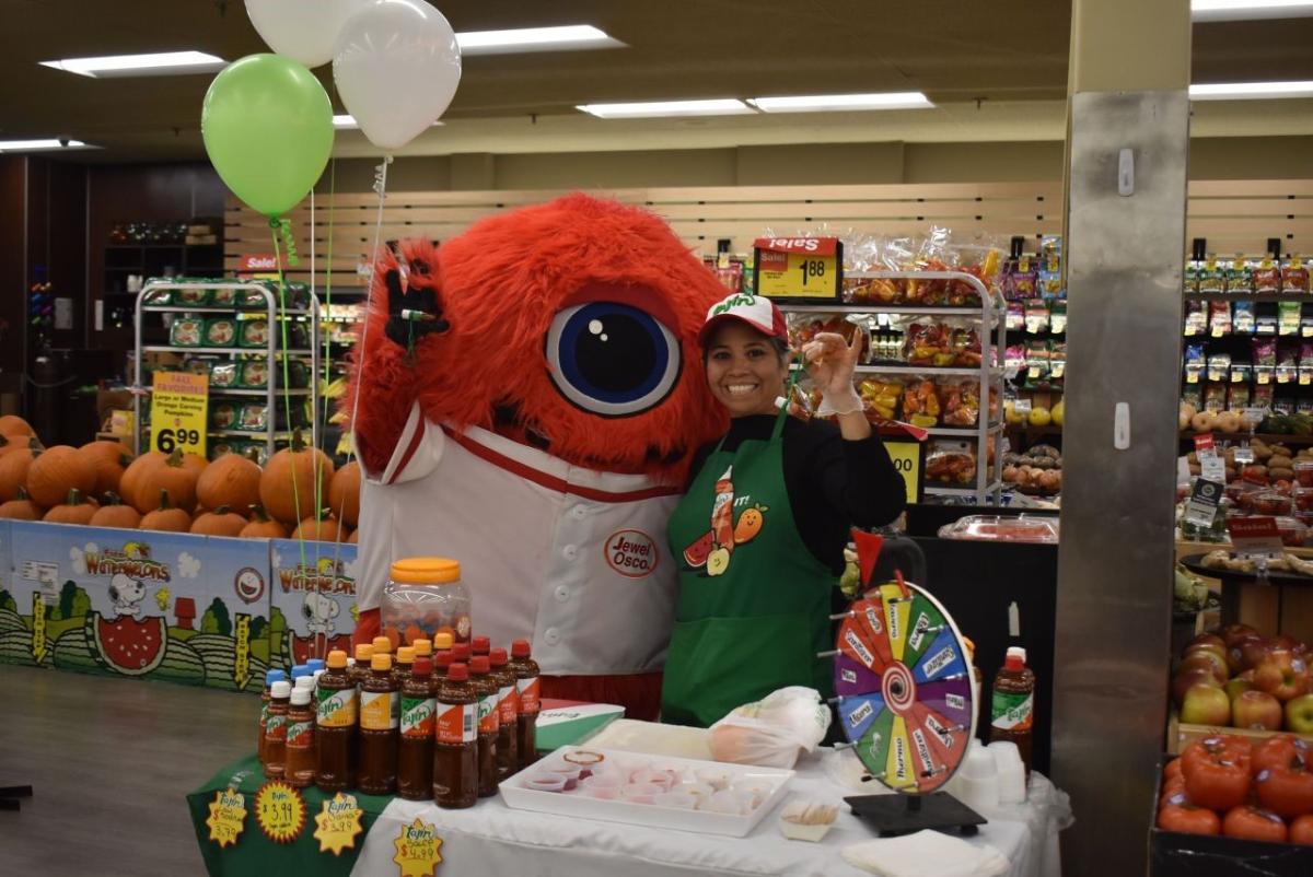 Jewel-Osco's JoJo mascot poses with person hosting booth.