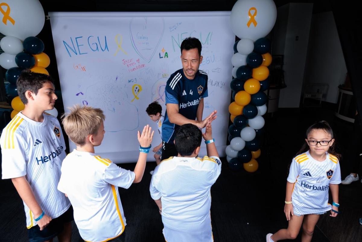The NEGU youth and their families met the LA Galaxy players before starting the Boot Making Lab.
