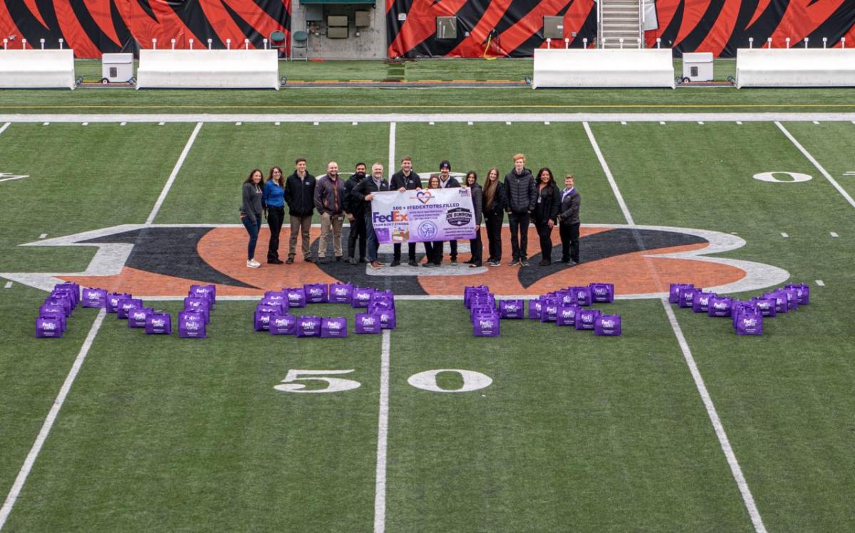 A group of people stood on a football pitch 