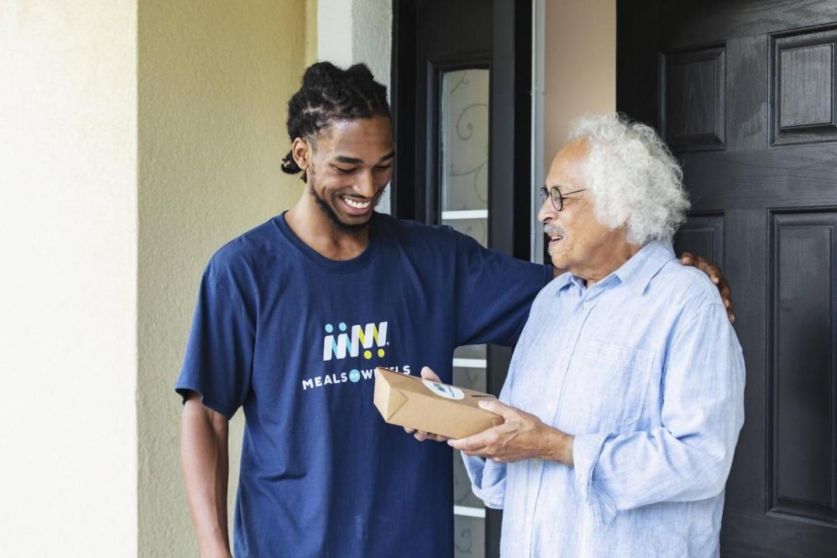 A meal is delivered to a Meals on Wheels recipient