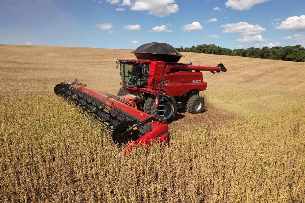 Red farm machine in a golden field