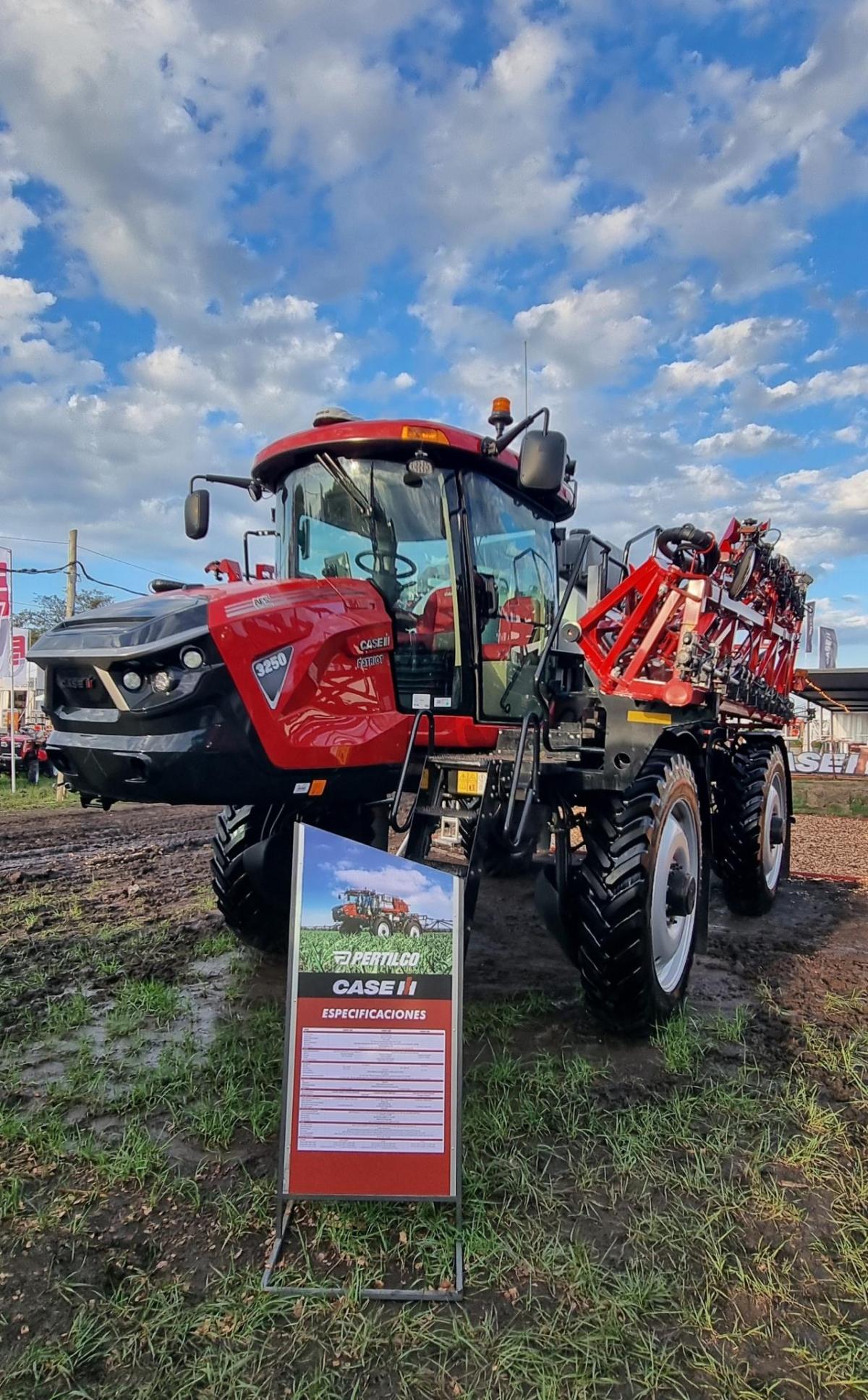 Tractors and equipment in a field under a cloudy sky