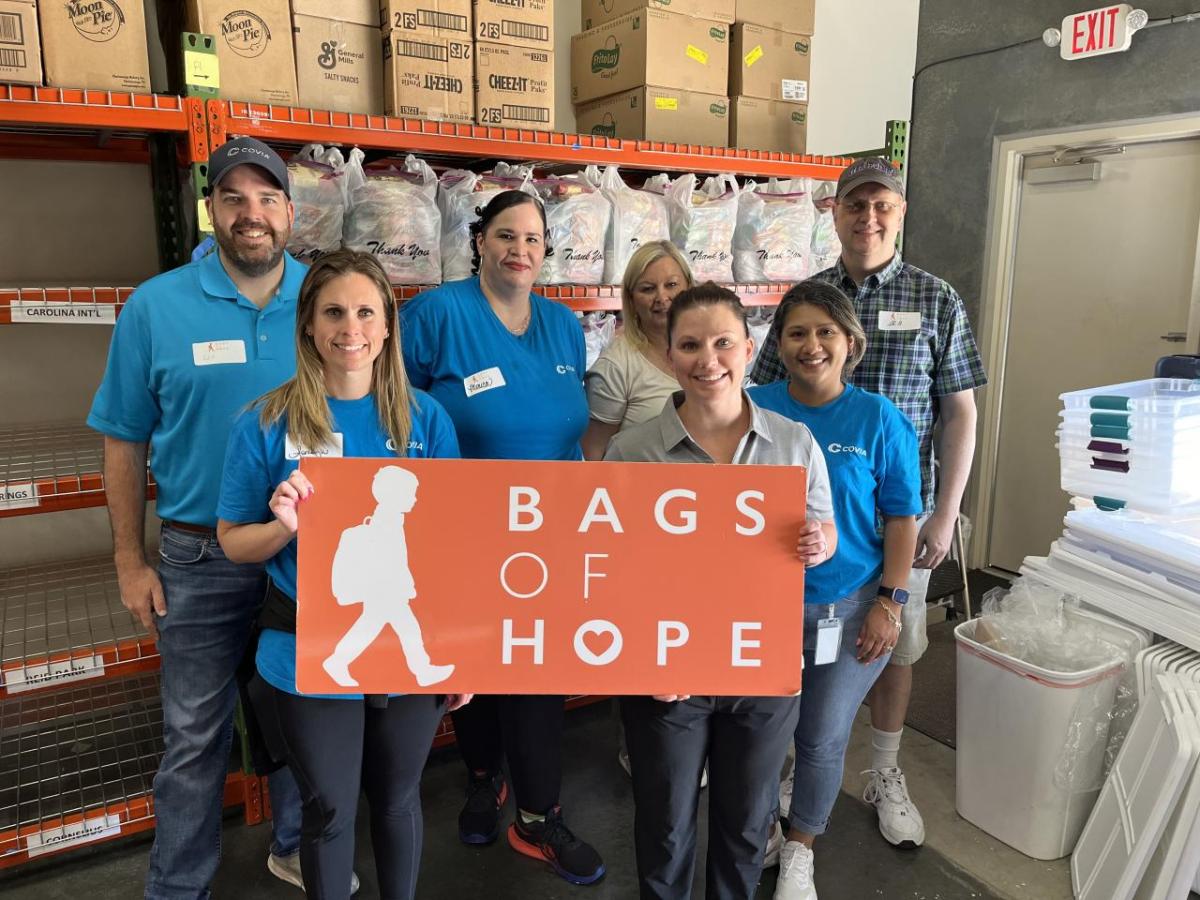 People standing together, holding a "Bags of Hope" sign