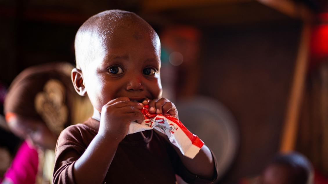 A child eats RUTF.