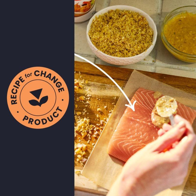 Albertsons Recipe for Change product logo next to a hand spooning mustard onto a piece of salmon.