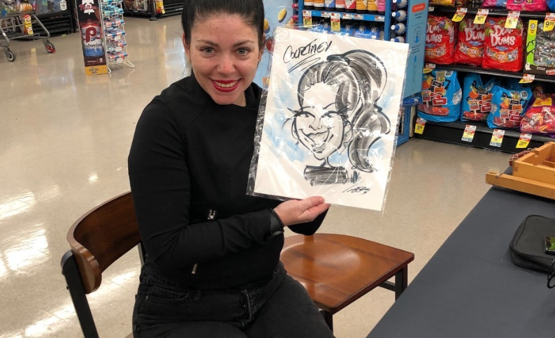 Someone posing with their caricature