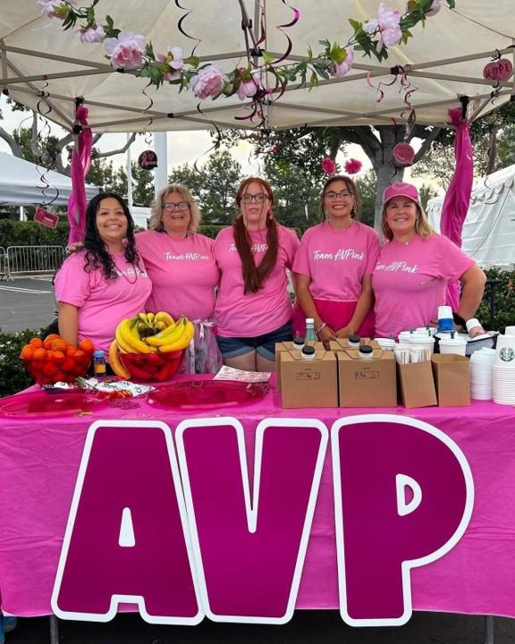 People pose at the AVP booth at the Orange County, CA Susan G. Komen More than Pink Walk.