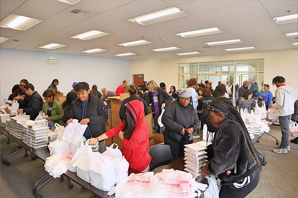 People picking up meals at the food distribution service