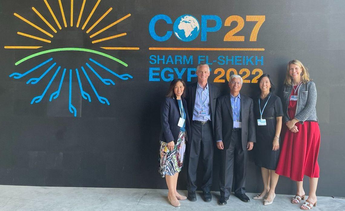 group photo in front of COP27 sign