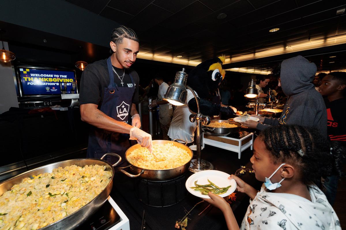 LA Galaxy defender Jalen Neal helps serve families in need at the 20th annual Thanksgiving Foundations’ Feast.