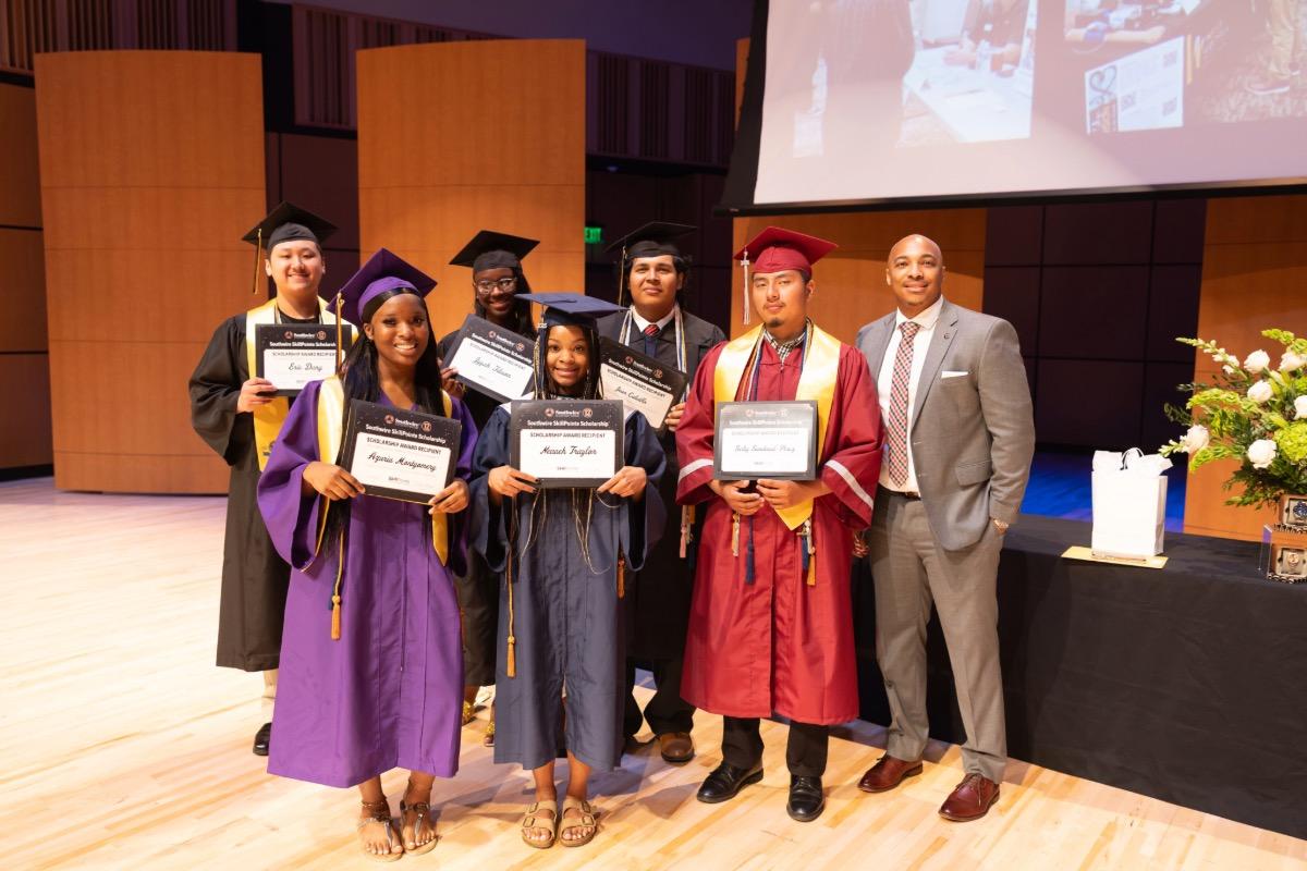 Students holding scholarship certificates