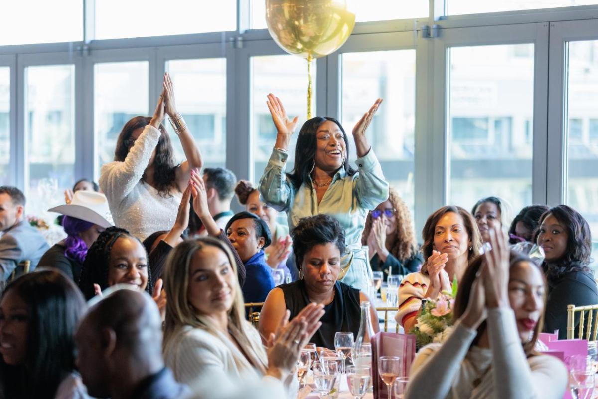 Attendees at the 10th annual Women in Entertainment Luncheon congratulate the honorees.