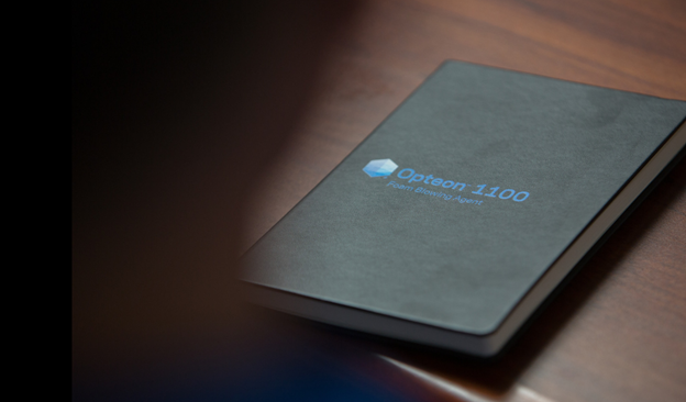 a black book with a logo for Opteon 1100 on the cover