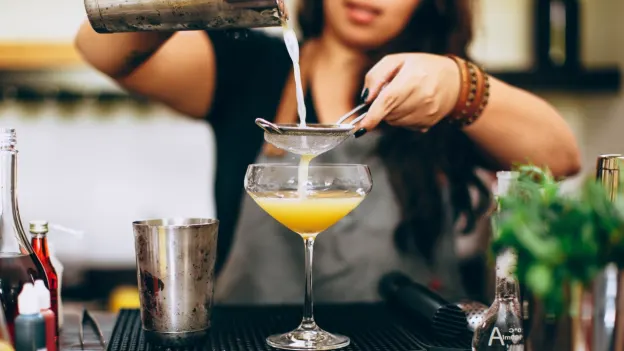Person mixing a cocktail