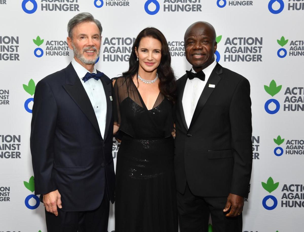 Raymond Debbane, Kristin Davis and Dr. Charles Owubah pose for a photo.