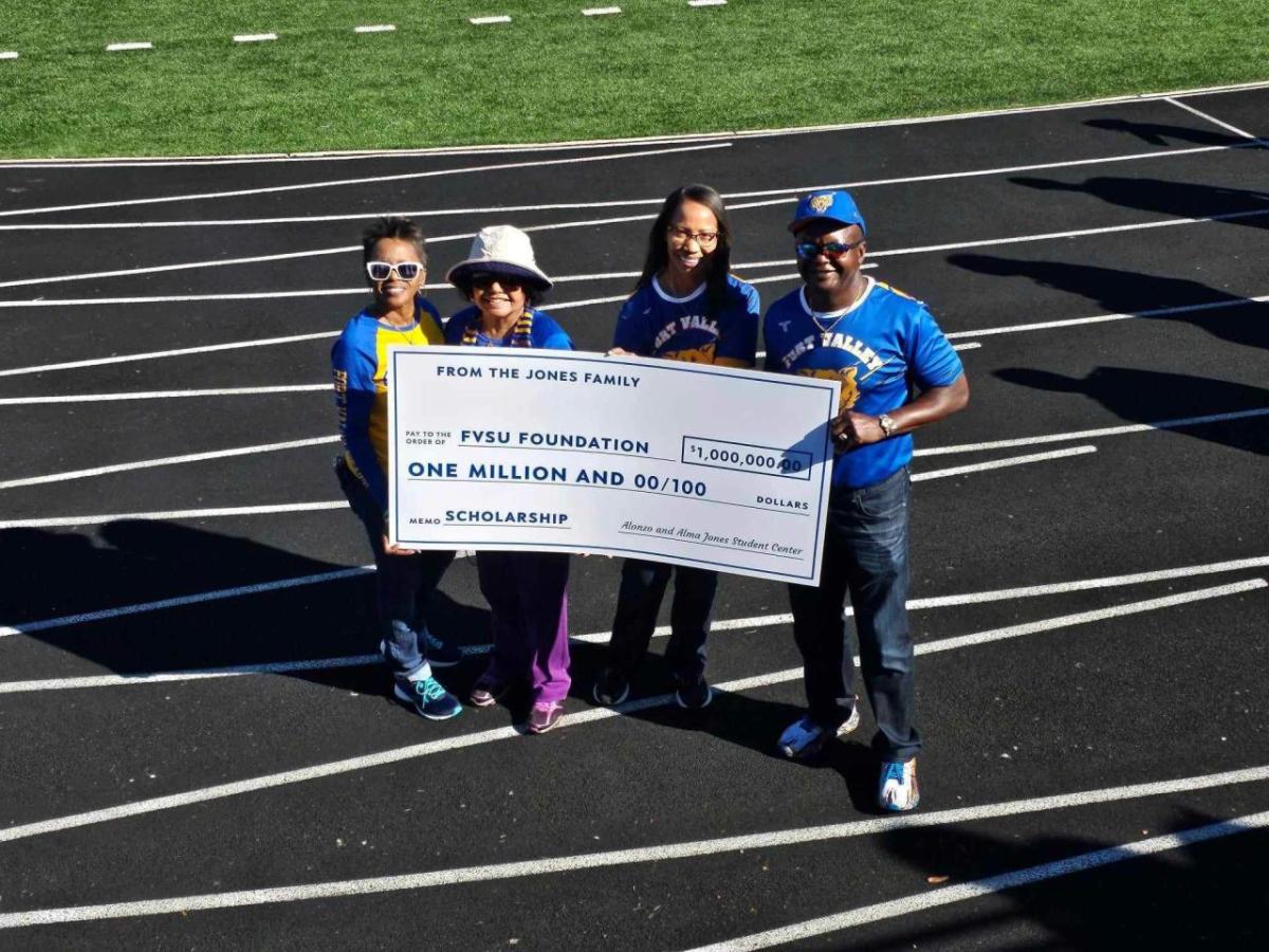 A group of people holding a cheque 