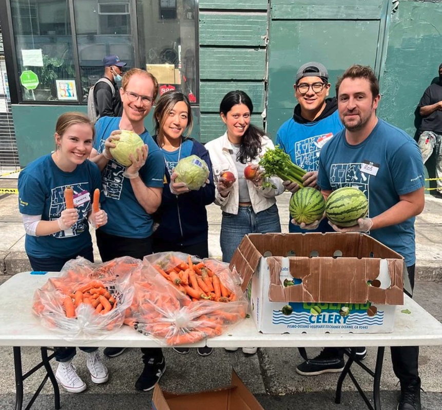 Group holding produce and smiling