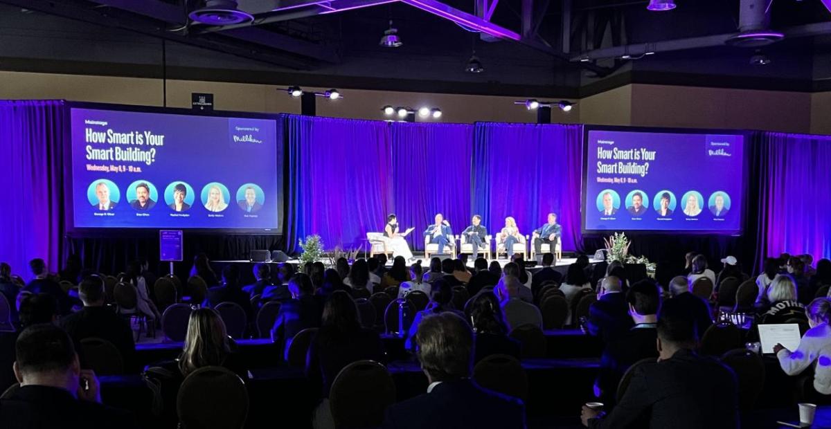 People sat on stage in front of an audience at the 2024 WELL Conference