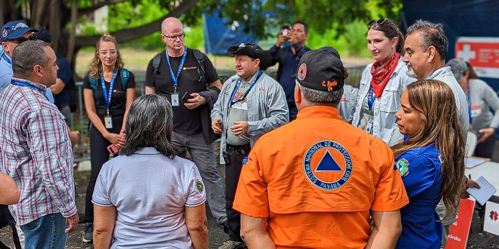 People standing outside in a circle having a discussion