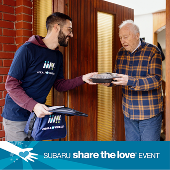 One person handing food to another in a doorway