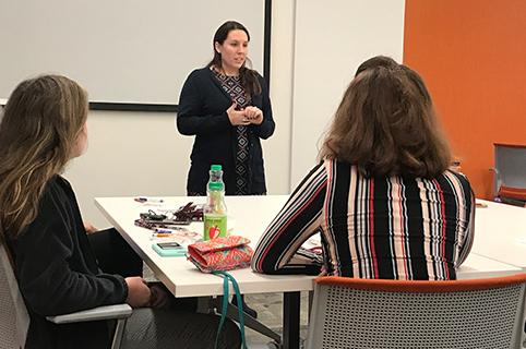 Brianna McMeekin, development program manager, speaks to high school seniors who visted PNC as part of their involvement in the PartnerUp program.