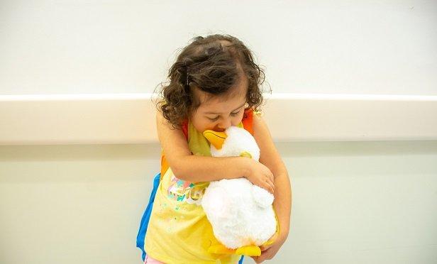 Sophia Zuniga, 3, hugs her My Special Aflac Duck robot. (Photo: Aflac)