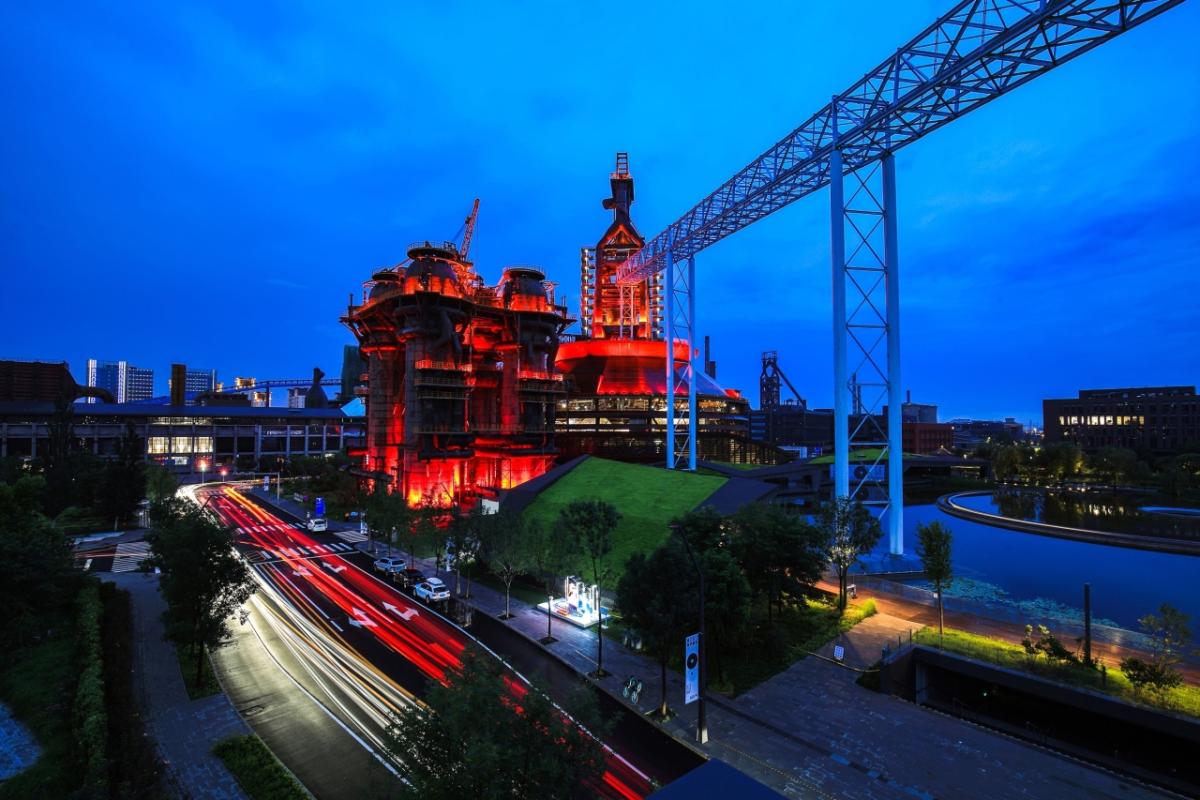 Beijing at night with a building lit in red