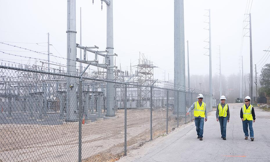 Wen Tong and two colleagues at a substation