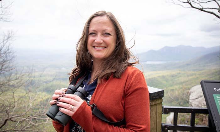 Jennifer McCarthey Tyrrell holding binoculars