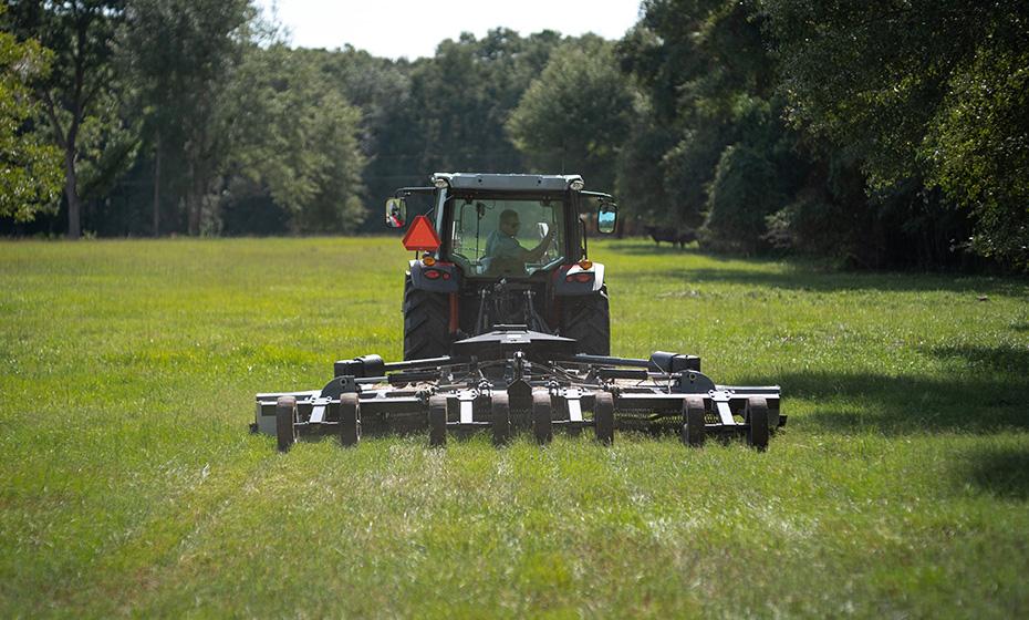 Slade Williams in a tractor on a grassy field