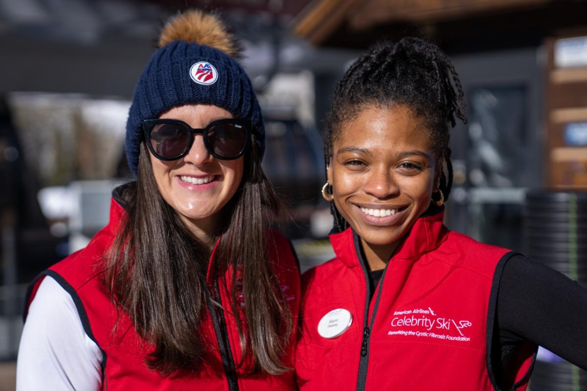 Two women wearing "Celebrity Ski" vests