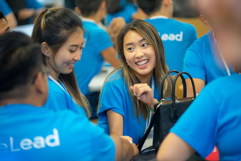 people in blue shirts smiling