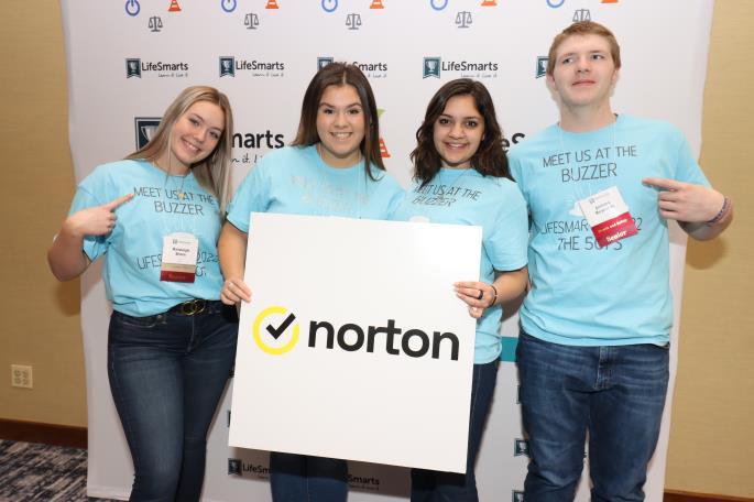 4 students holding a Norton sign