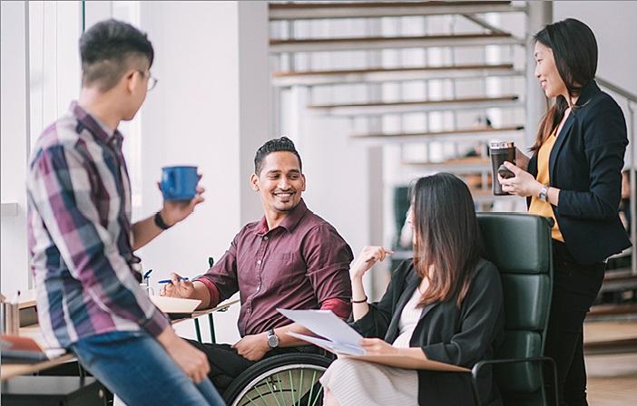 group of four colleagues talking