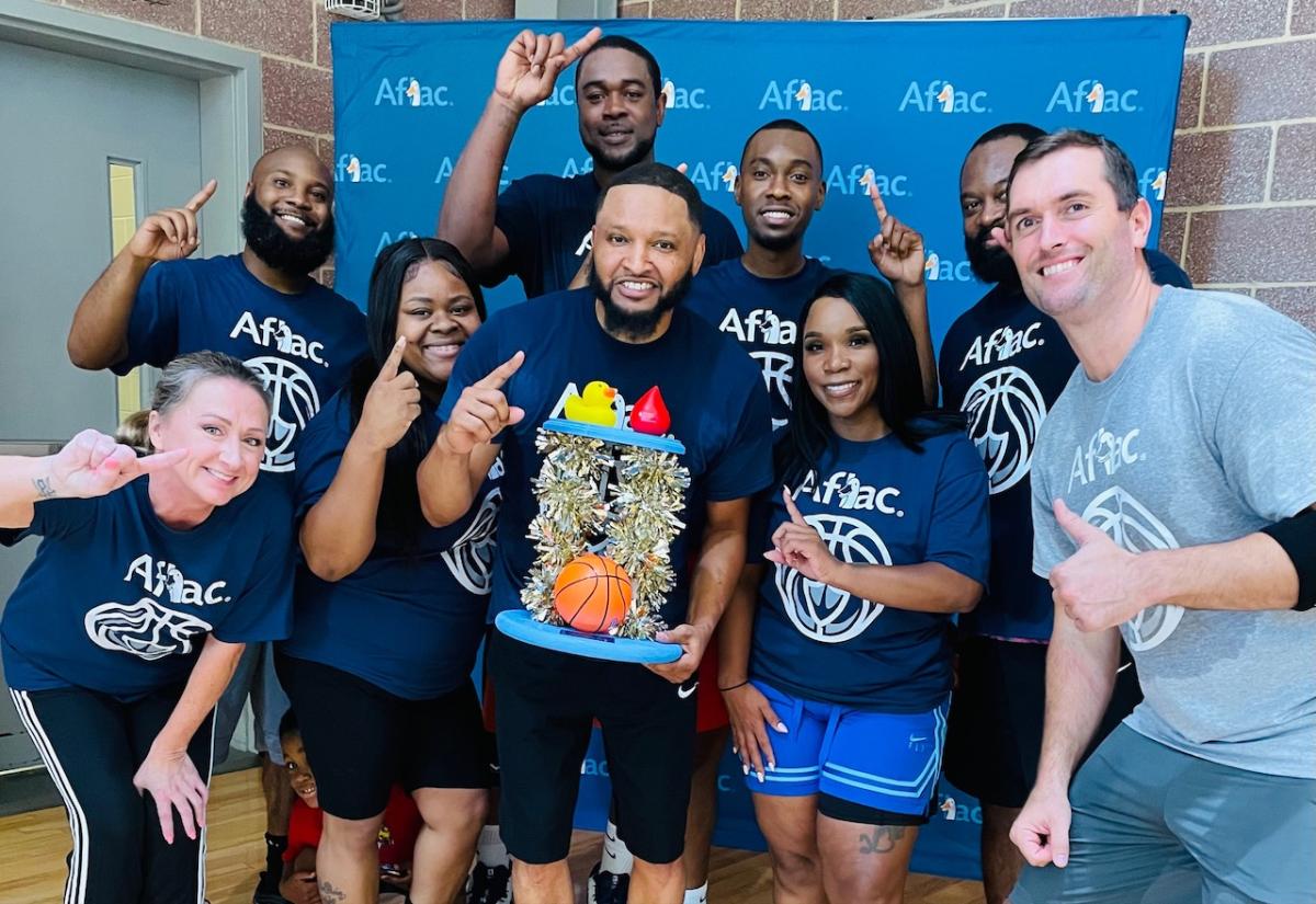 The winning team and top fundraisers — Aflac Employee Team:  Front row: Erica Cavanagh, Melissa Davis, Kendall Saxon, Veronica Goodwin, with Bob Ruff. Back row: Brandon Smalls, Quan Prowell, Refeno King, Jordan Vernon.